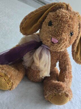 Brown bunny plushie with purple and cream tulle bow